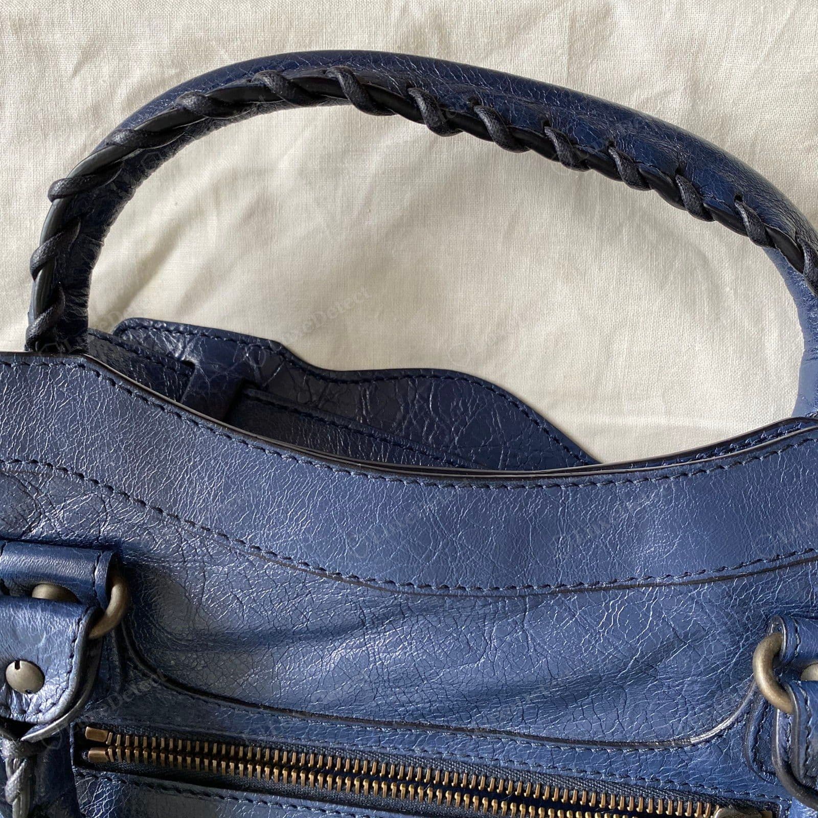 Genuine Balenciaga City lambskin — a deep blue bag with fine random crinkle, a matte dry surface and tonal colour depth, the whipstitched handle laced through in matching leather