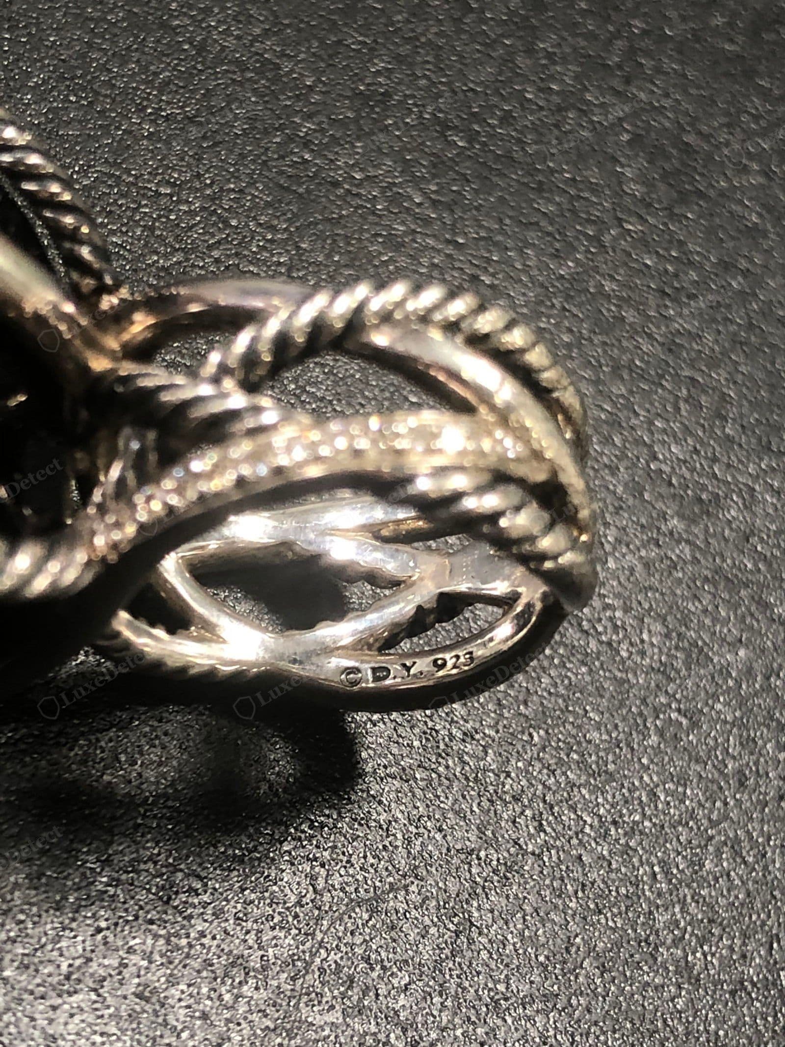 Genuine David Yurman cable — a tight, evenly twisted helix with a consistent pitch, crisp defined turns and clean grooves, solid weight, and a crisply struck "©D.Y. 925" hallmark