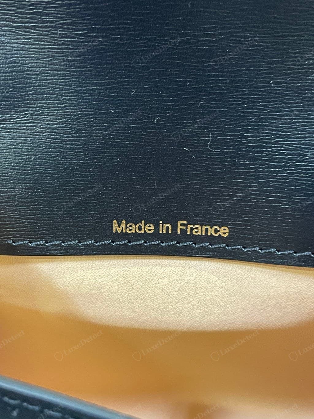 Counterfeit Delvaux heat stamp — clumsy or wrong serif, malformed letters, uneven or crooked emboss, wrong origin format