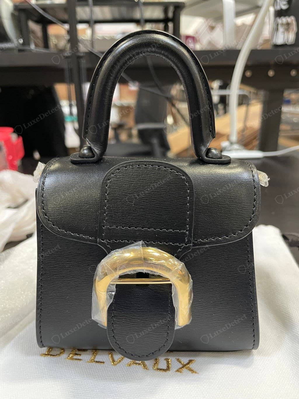 Counterfeit Delvaux Brillant — proportions off, a flap that does not follow the body line, an off-centre or oversized clasp