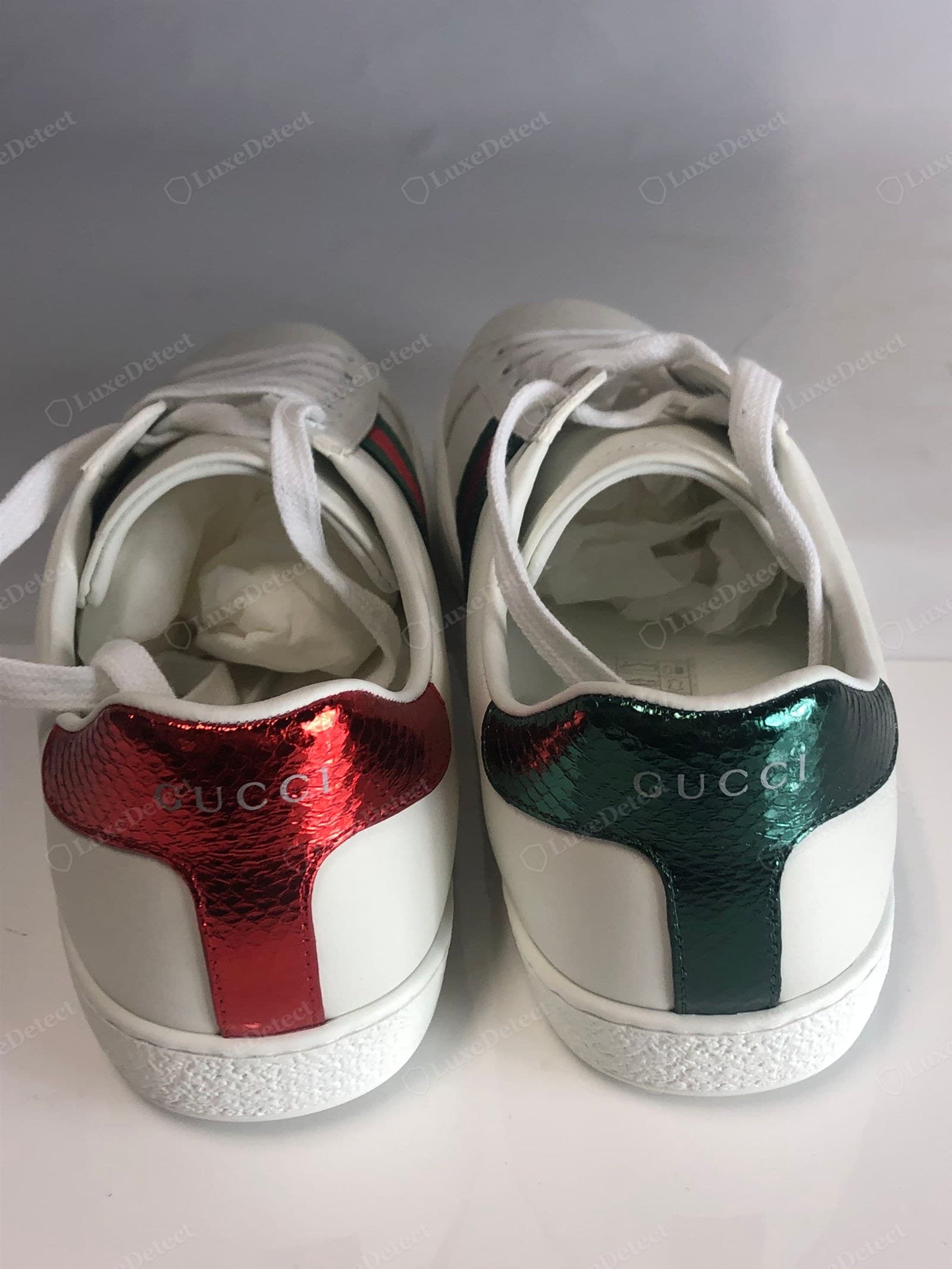 Counterfeit Gucci Ace heel logo — a fuzzy, mis-proportioned, or shallow "GUCCI" on the heel