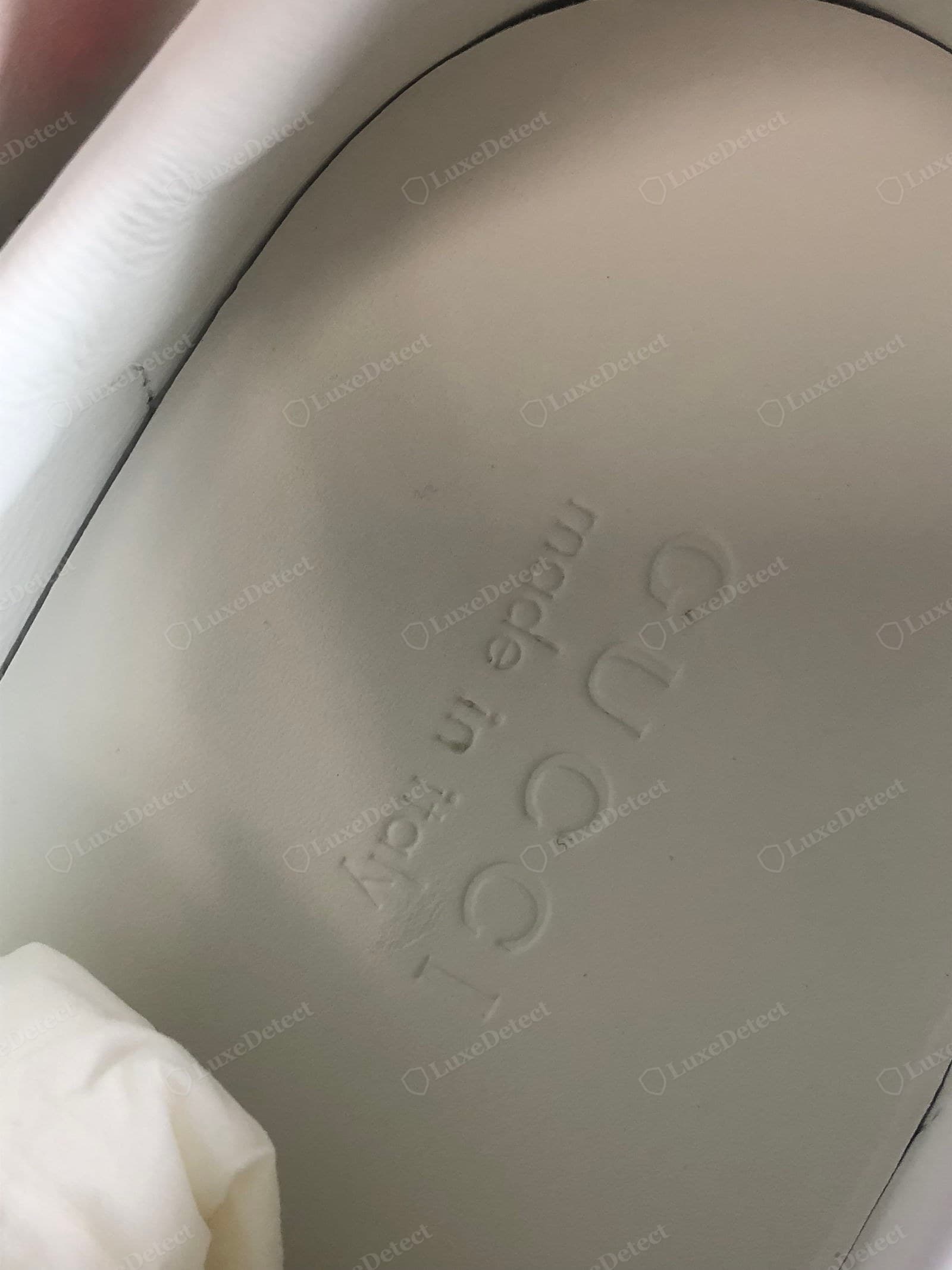 Counterfeit Gucci Ace insole — blurry or pixelated print, misshapen GG logo, wrong font, off-centre, lifting edges