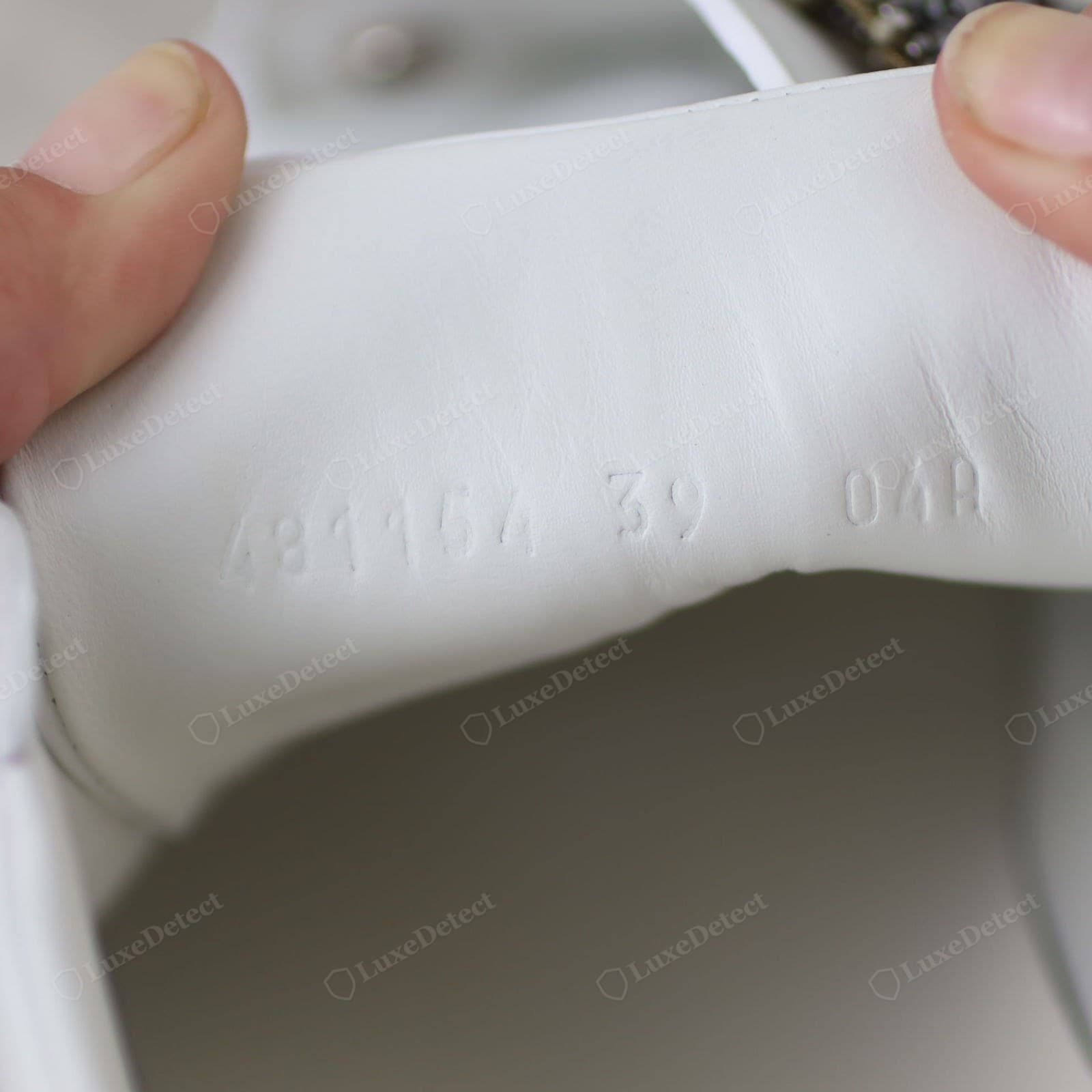 Genuine Gucci Ace size / style embossing — the size and style number stamped cleanly into the sole or a tongue tab in the house font