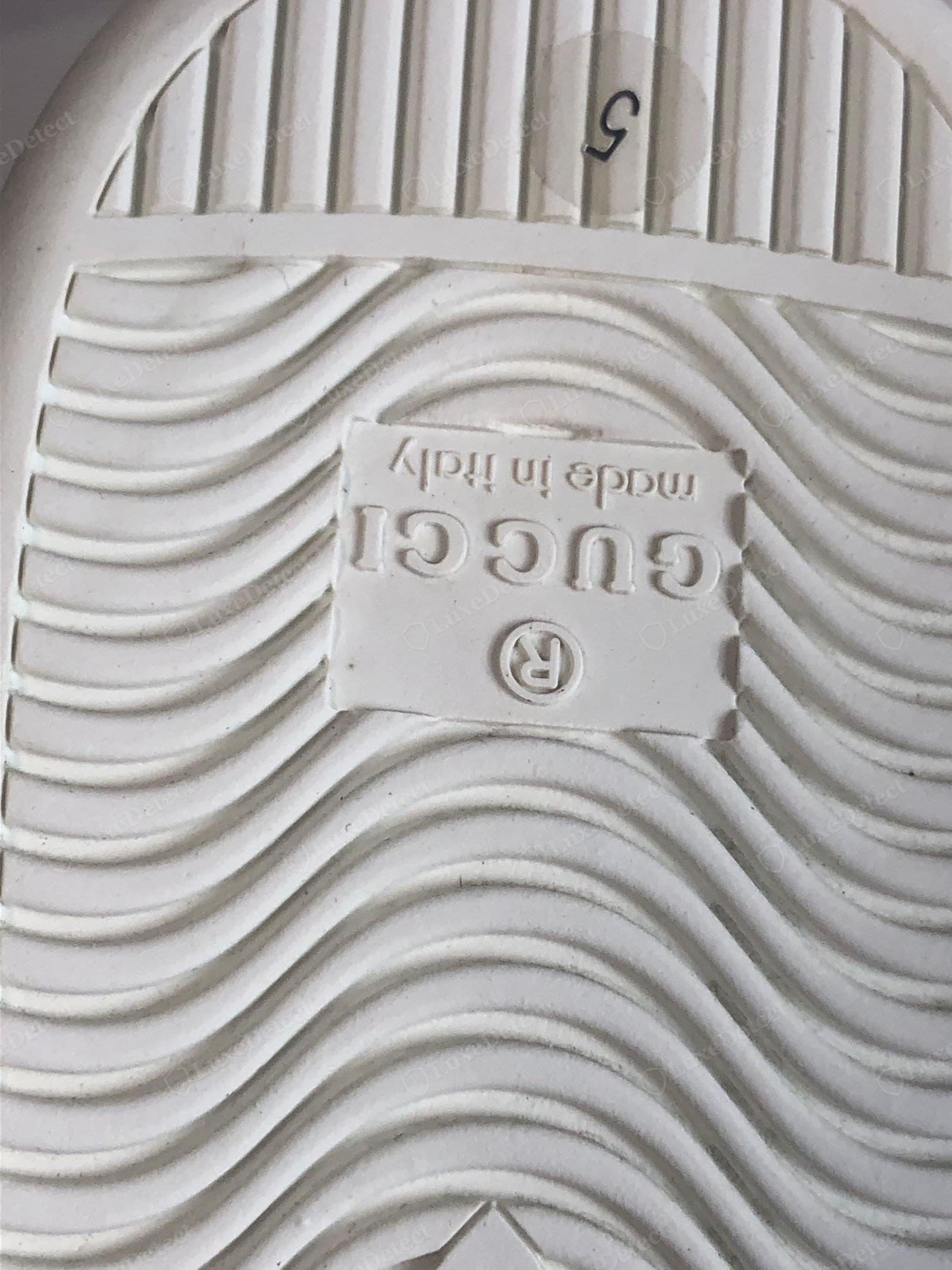 Counterfeit Gucci Ace sole — shallow blobby text, capital M in "Made", wrong size format, soft rubber, mould flashing