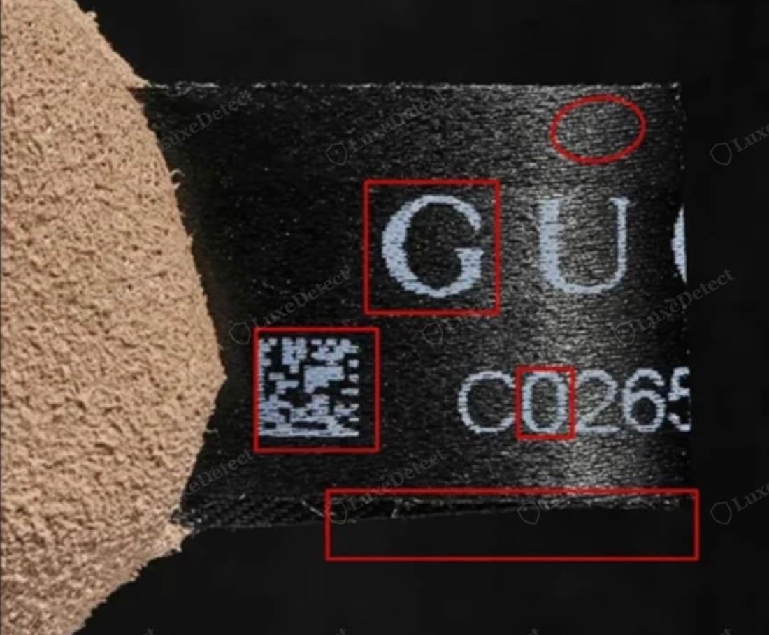Genuine Gucci black label with the encrypted QR code and printed serial number, key authentication points circled: the crisp embroidered GUCCI lettering, the dense QR block, the straight-sided number style, and the flush seam stitching