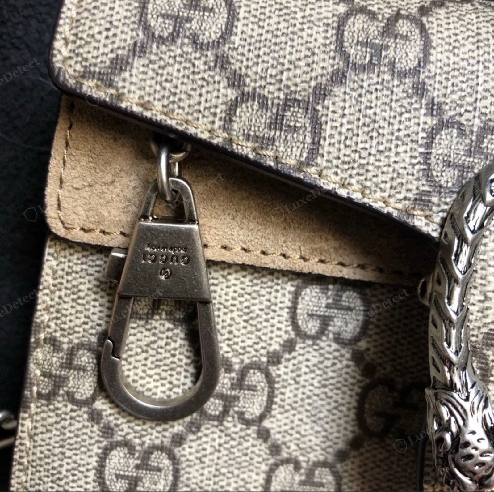 Counterfeit Dionysus canvas: an over-pronounced woven basketweave texture showing through a thin coating, the GG print soft and slightly blurry, pale rough leather trim edges, and a soft mushy tiger head on the right