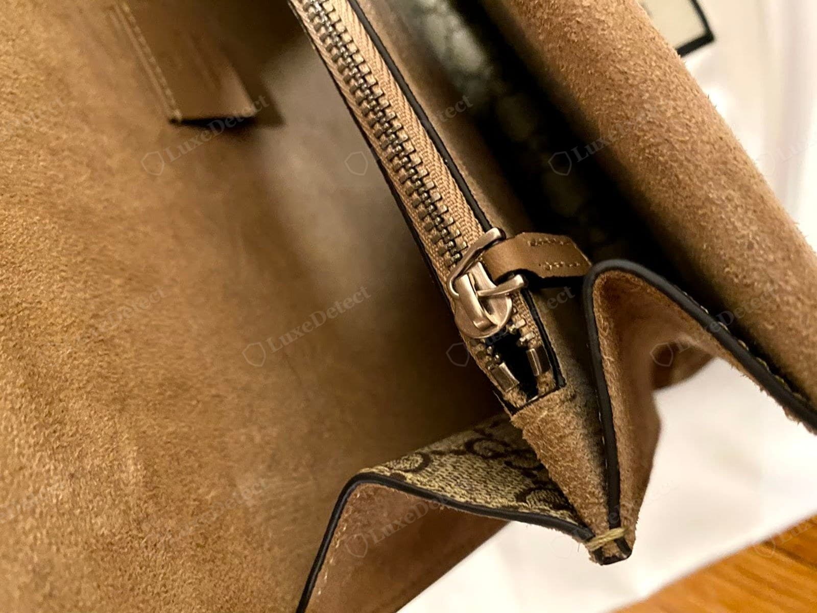 Counterfeit Dionysus interior: a thin fibrous microsuede lining with raw, unfinished seams and thin edge paint letting the tan base show through