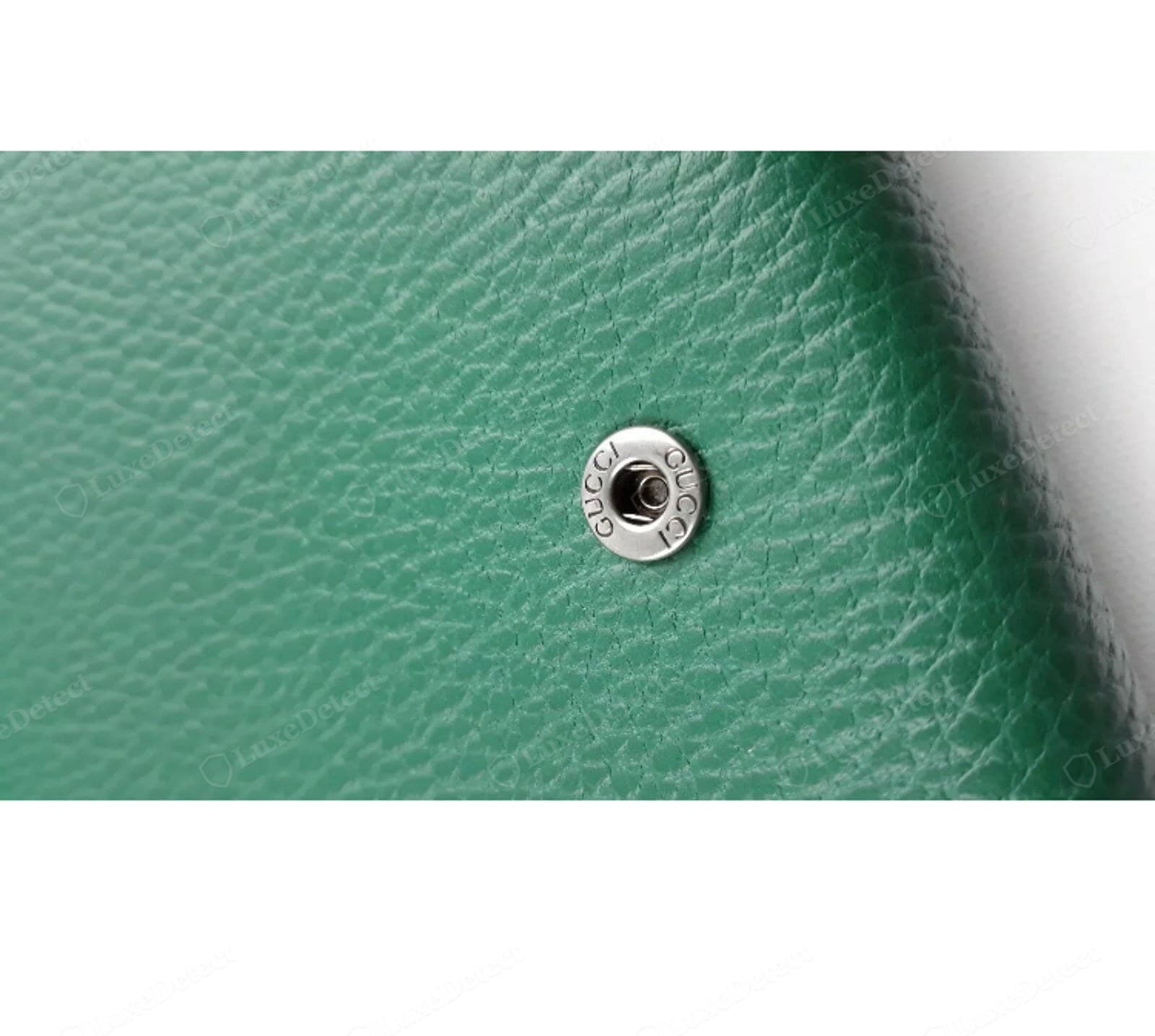 Genuine Dionysus interior snap: engraved "GUCCI" around the rim, crisp and even, set into green pebbled leather
