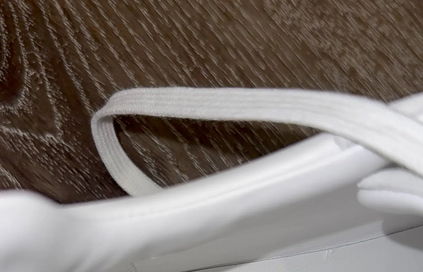 Interior lining code on a white pair — FR1 242810ZH 43 2511, printed into the leather along the inner quarter panel