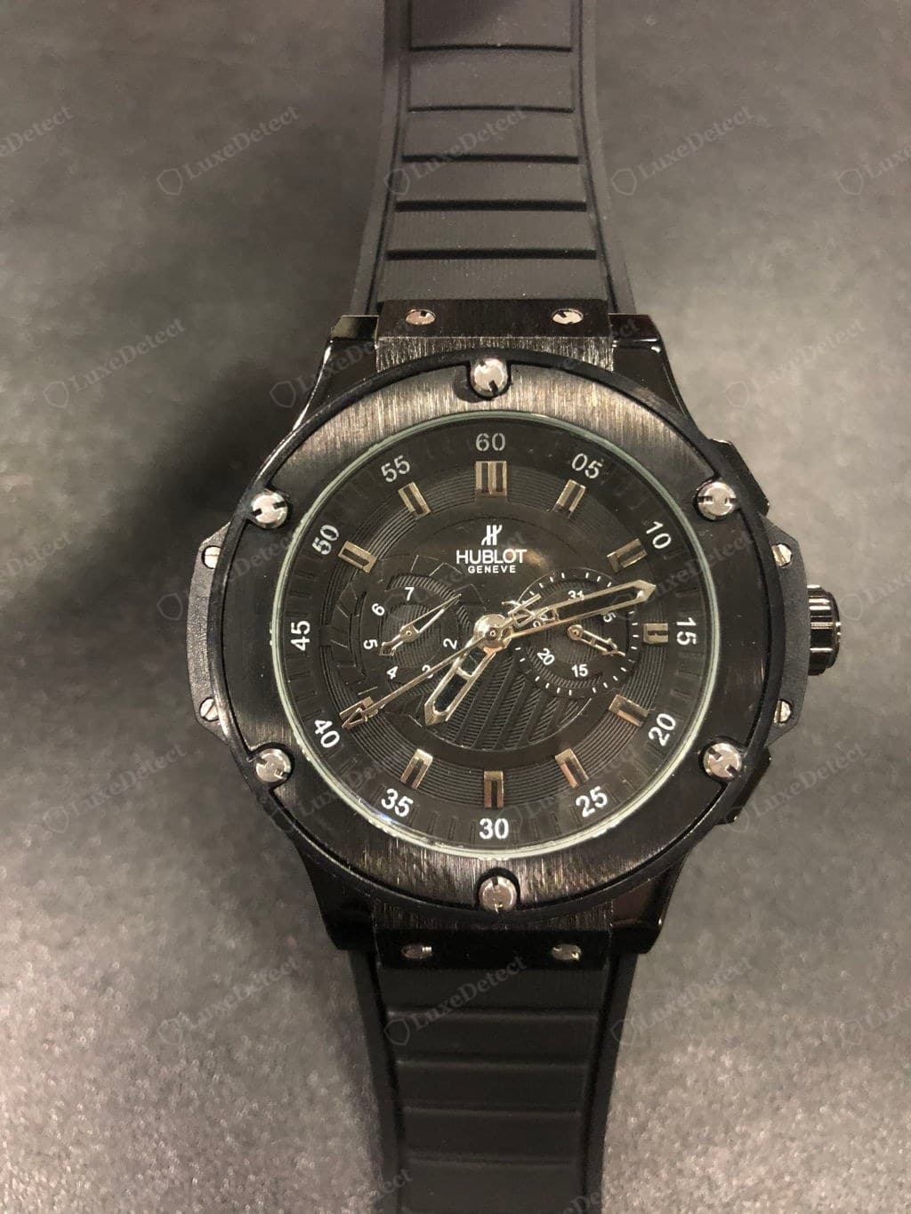 Counterfeit Hublot caseback — shallow or fuzzy engraving, screws at random orientations