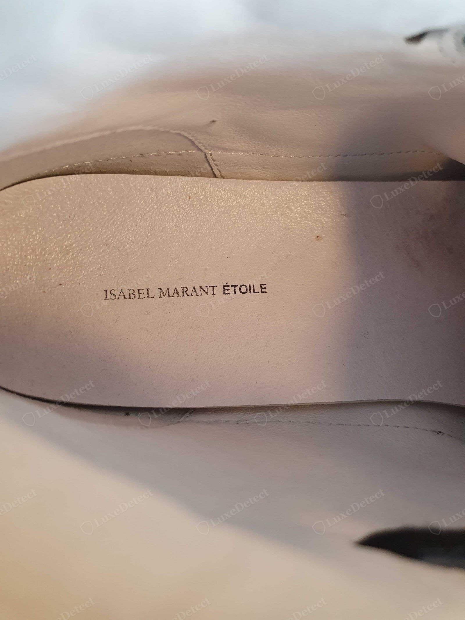Genuine Isabel Marant Étoile footwear — "ISABEL MARANT ÉTOILE" stamped cleanly on a pink leather insole in the spaced serif with the accent on ÉTOILE, the leather smooth and even