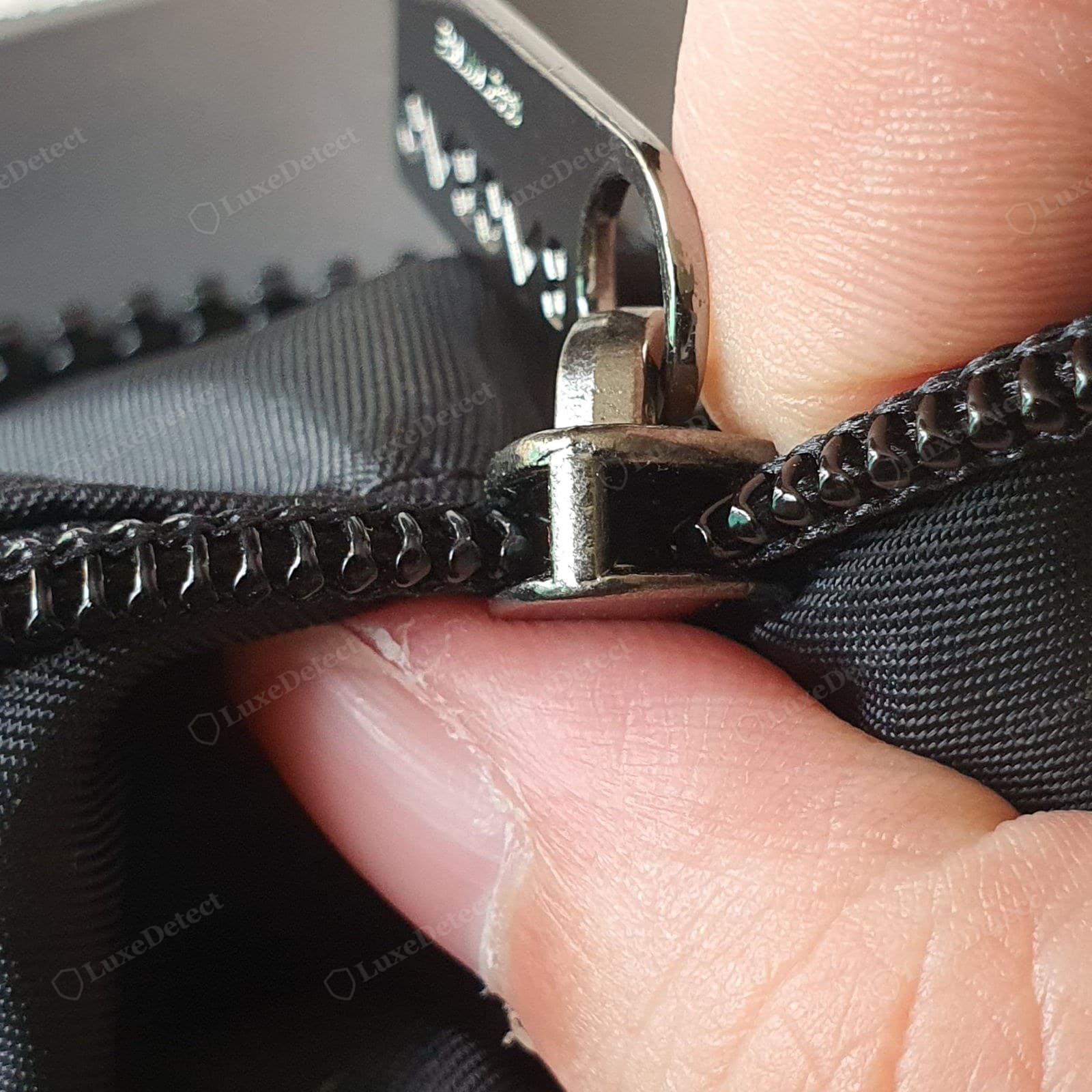 Genuine BAOBAO interior — a branded logo-jacquard lining and a YKK-stamped zip slider body