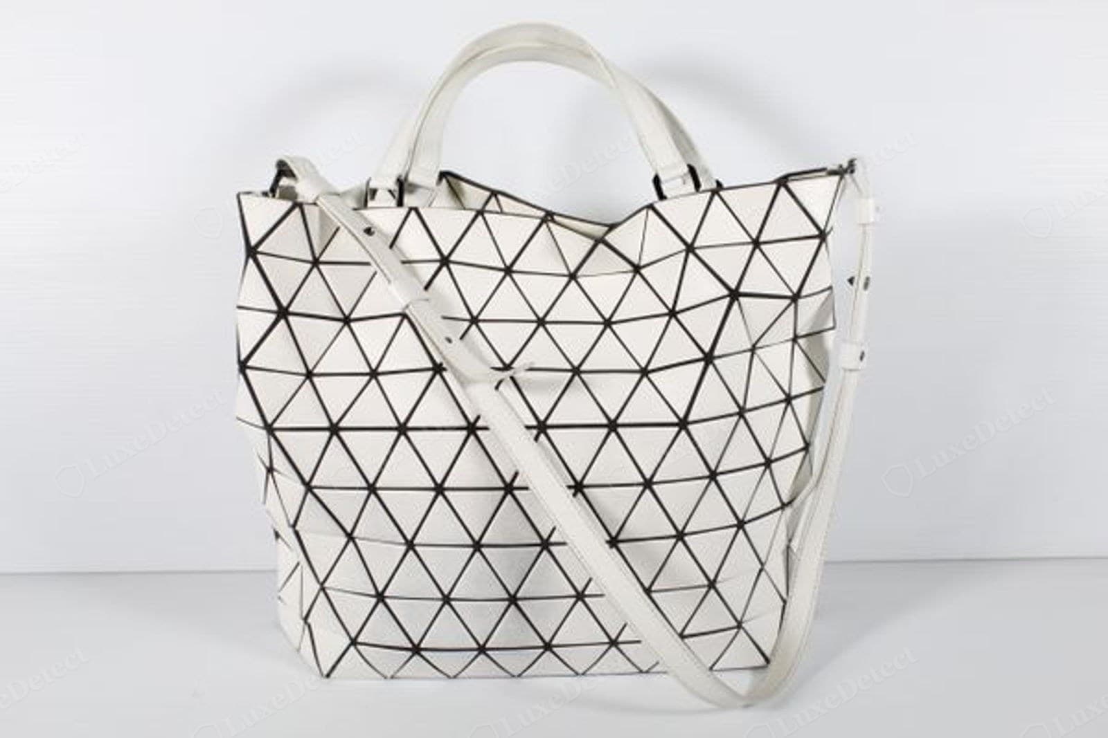 Counterfeit BAOBAO tote overall — the irregular triangle grid is visible across the whole panel, tiles buckling and the silhouette sagging
