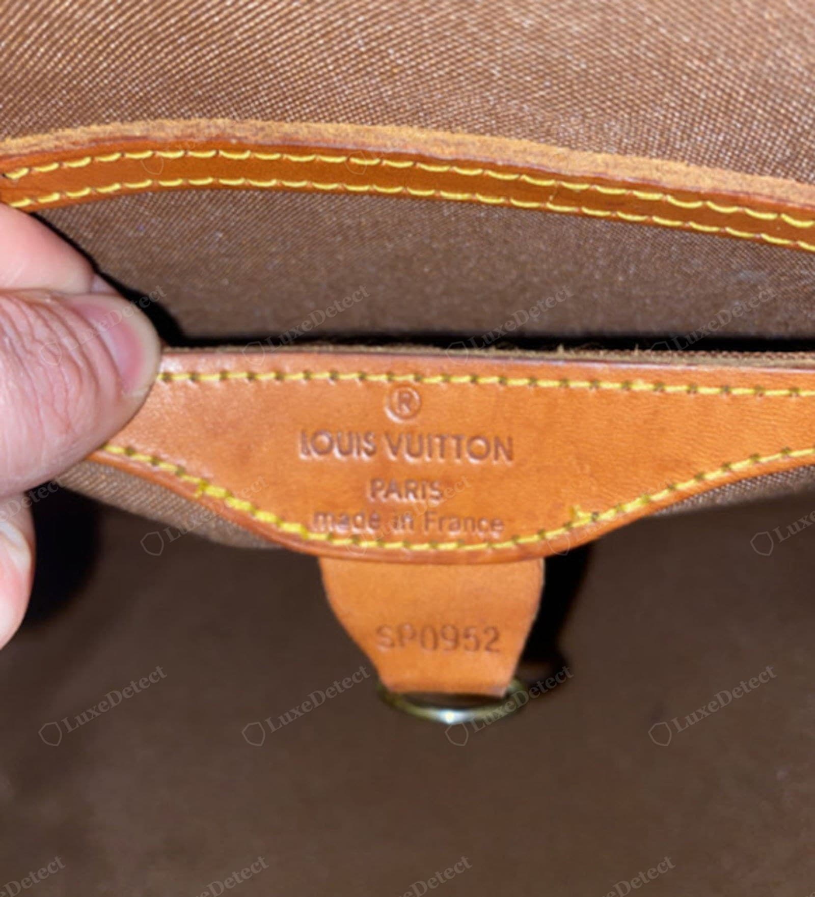 Counterfeit LV Alma heat stamp — wrong font, oval Os, capital M in "Made", uneven baseline, too deep or faint