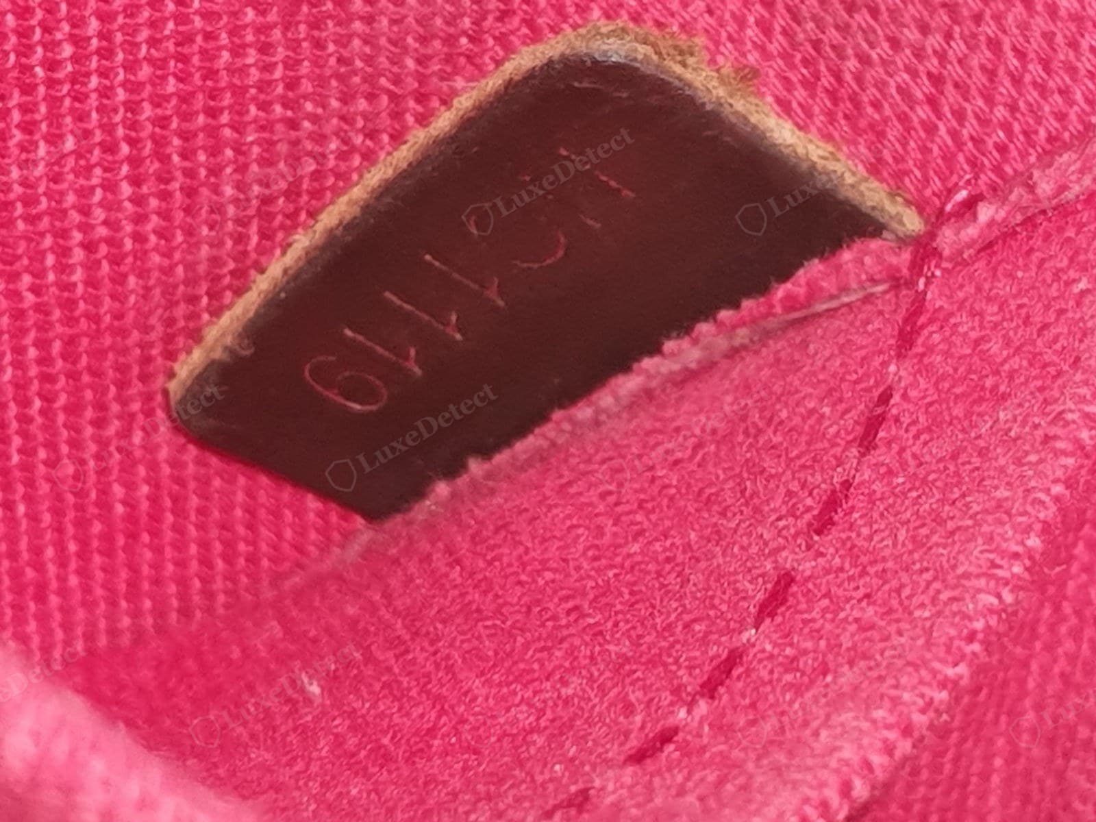 Counterfeit LV Alma date code — a wrong font, an impossible week or letter combination, or a code stamped on the exterior where it should be inside