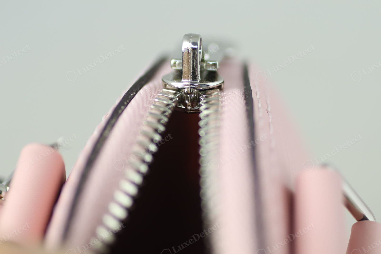 Genuine LV Alma — the zip runner and the twin side zips meeting neatly at the base of the dome