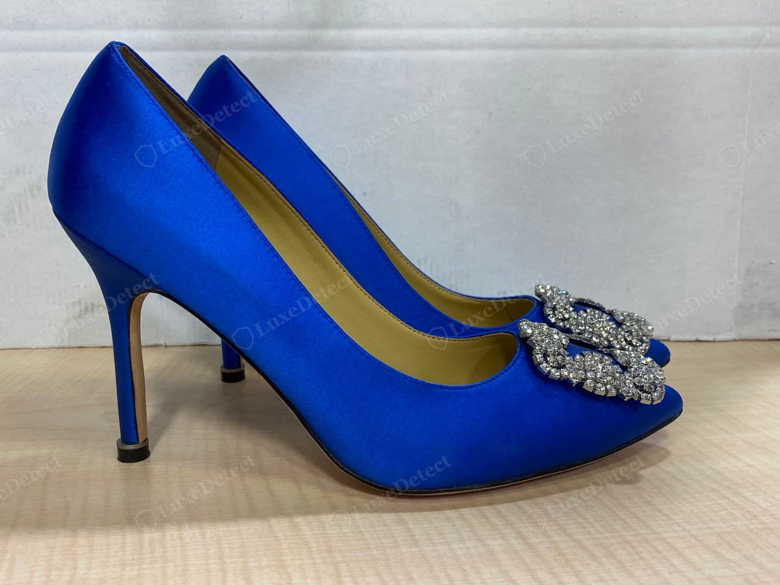 Counterfeit Manolo Blahnik last — a side-by-side pair of cobalt fakes; the heel is a touch thick and the vamp line sits high, the proportions reading heavier than the genuine last