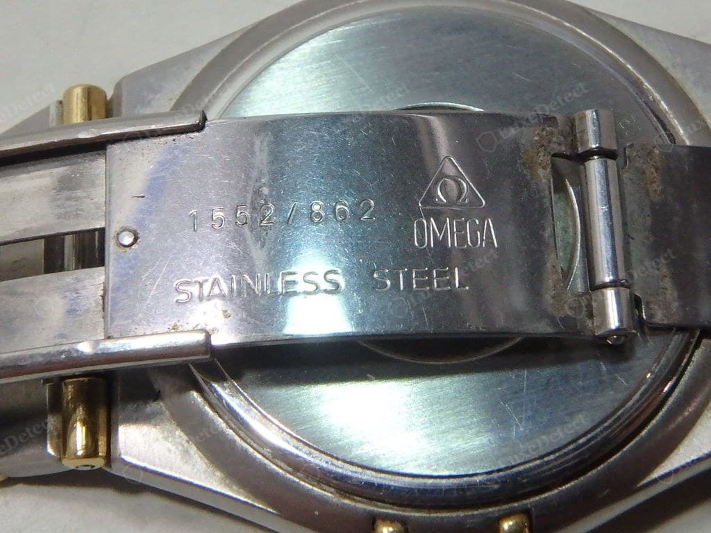 Genuine Omega bracelet and clasp — solid links, even brushing, a crisply formed Omega logo on the clasp, end links flush to the case
