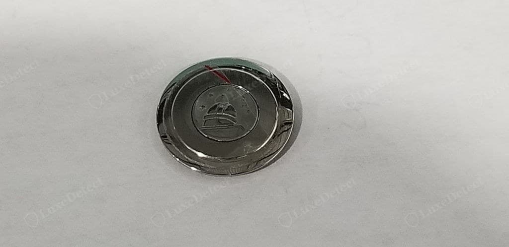 Counterfeit Omega caseback engraving — shallow, acid-etched or unevenly stamped, uneven spacing