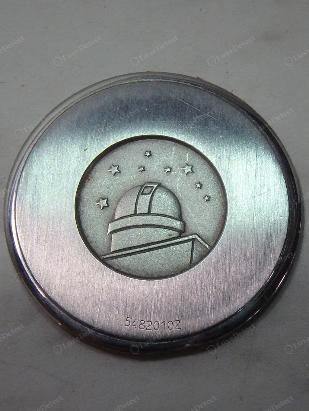 Genuine Omega caseback engraving — crisp, evenly spaced, consistent depth