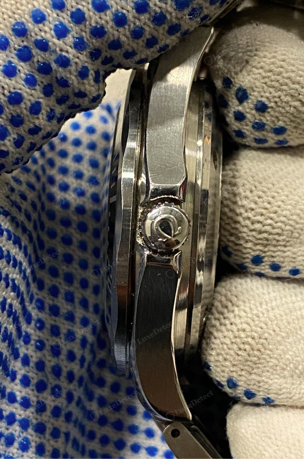 Counterfeit Omega crown — a shallow, soft, or misshapen symbol; often stamped rather than cut