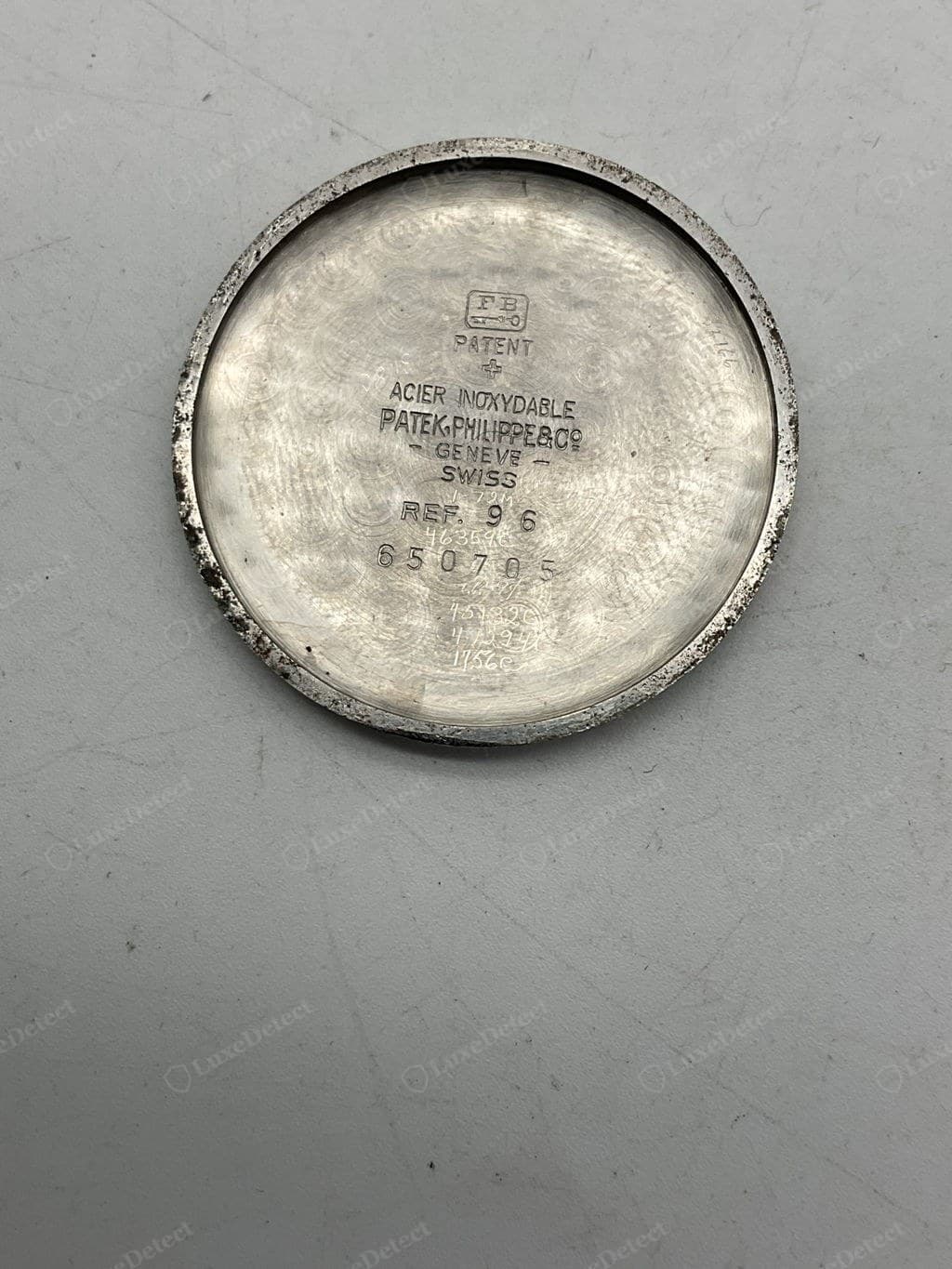 Genuine Patek Philippe caseback interior — reference and case-number engraving clean and correctly placed