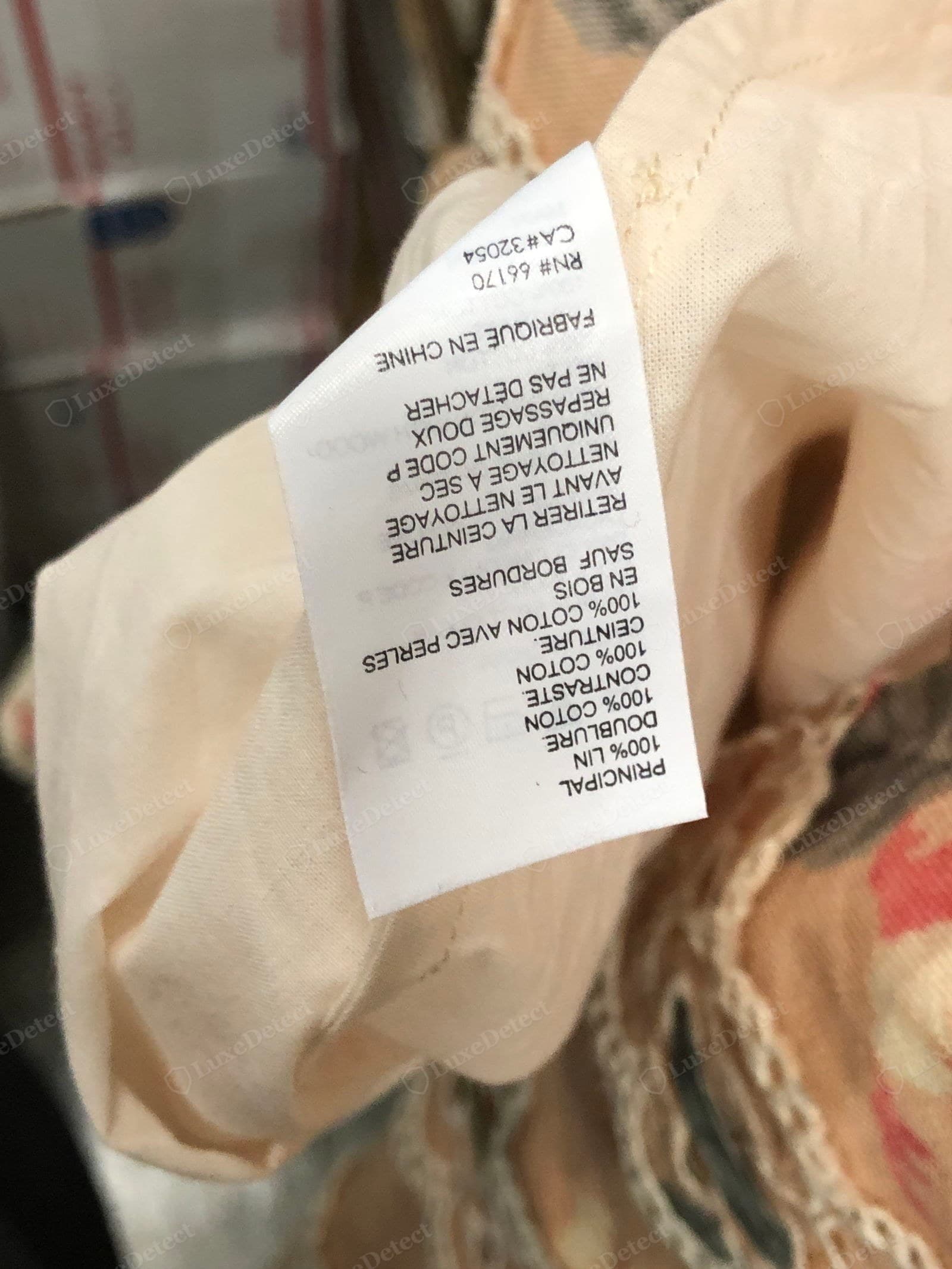 Genuine Zimmermann linen — a floral-print linen dress with its 100% linen / 100% cotton-lining care label and RN# 66170, the linen a substantial even matte weave finished with a fine scalloped crochet trim