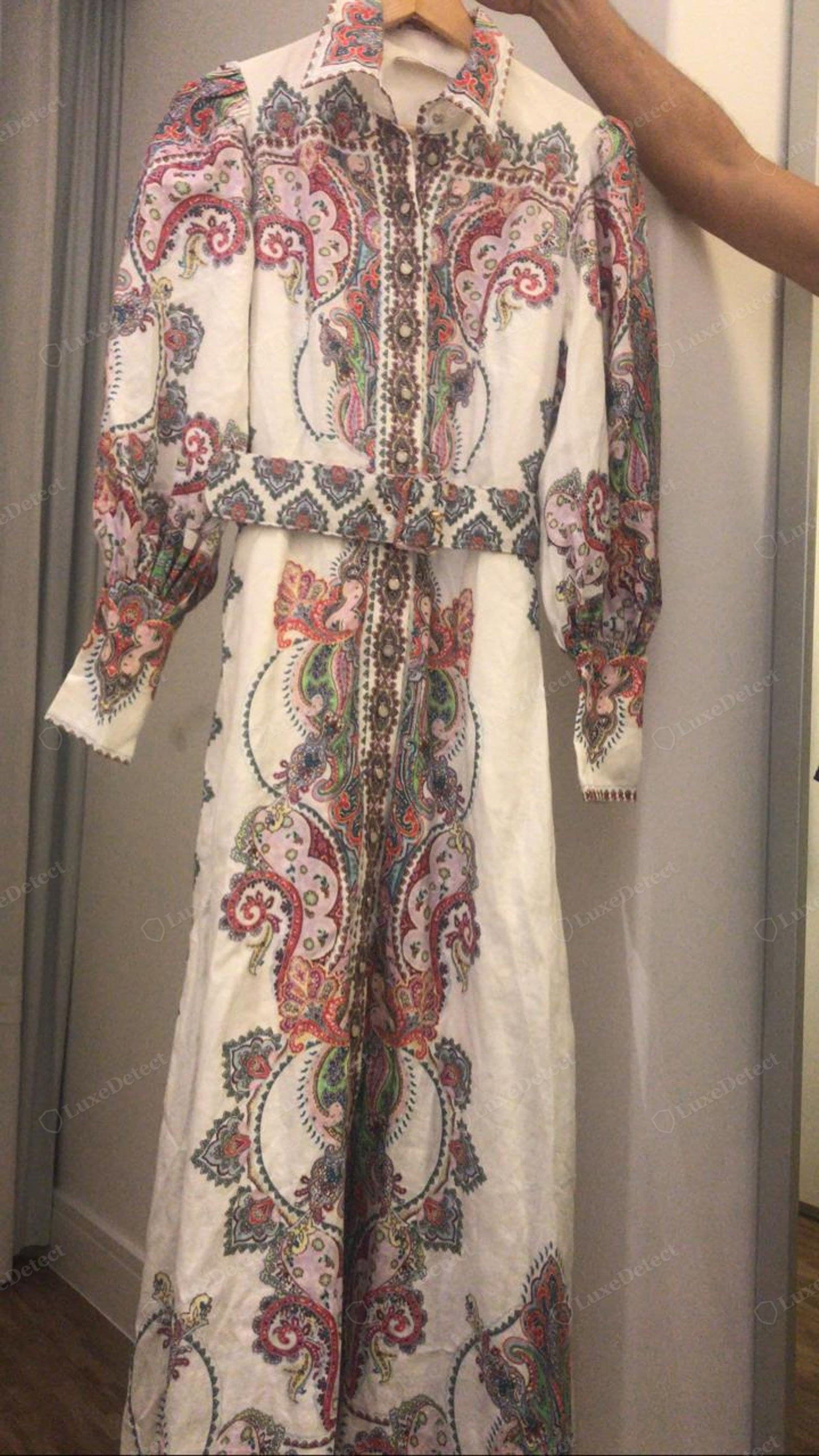 Genuine Zimmermann print — a linen paisley maxi dress showing engineered placement: the border print runs straight down the centre front, the motifs mirror symmetrically left to right, and the pattern is fitted to the panels, sleeves and self-belt with crisp colour registration