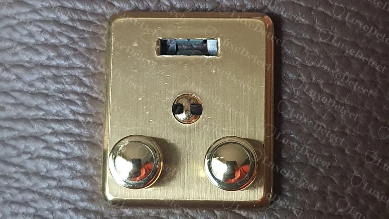 Genuine Pashli turn-lock: brushed gold plate with a slot at the top, a centre pin and two domed push buttons