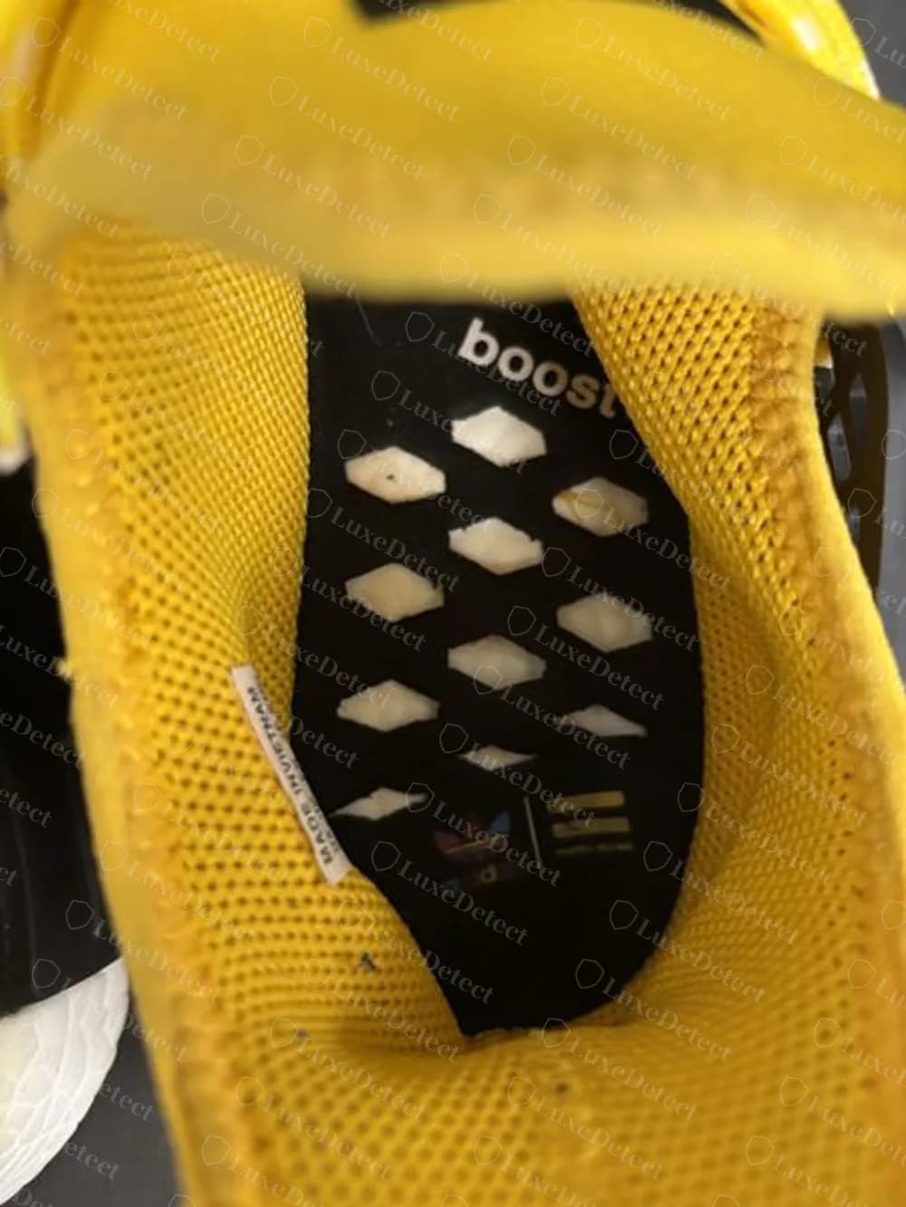 Counterfeit Hu NMD insole with a boost wordmark and diamond cut-outs instead of the body-parts print