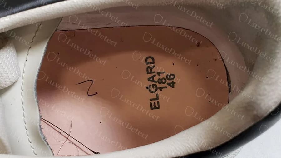 Genuine McQueen Oversized pair with the insole lifted: plain pink board stamped ELGARD with a number and the size