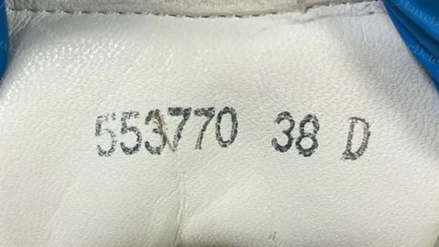 Counterfeit pair with a heel code in the correct layout: style number, size and width letter, yet the pair was fake