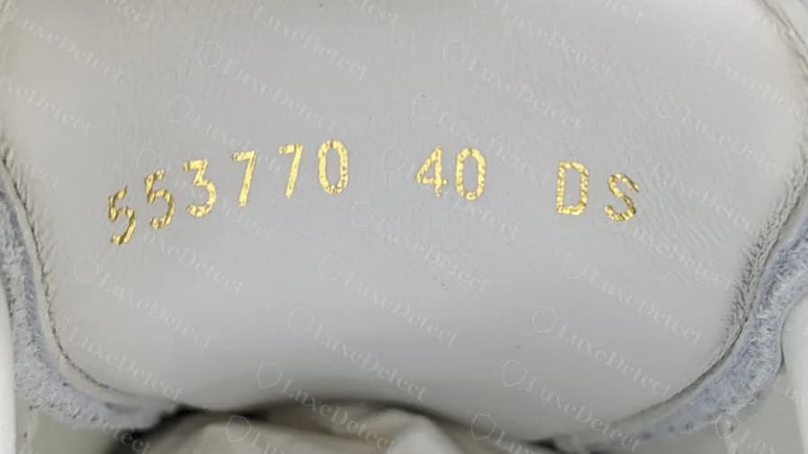 Genuine heel-tab stamp in gold: a six-digit style number, the EU size and a width letter
