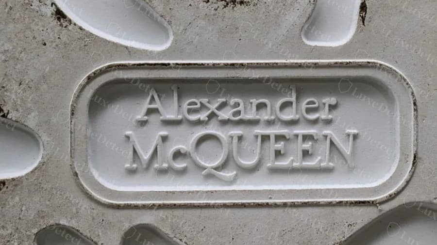 Genuine outsole waist: a raised rounded-rectangle Alexander McQueen stamp, sharp and evenly moulded