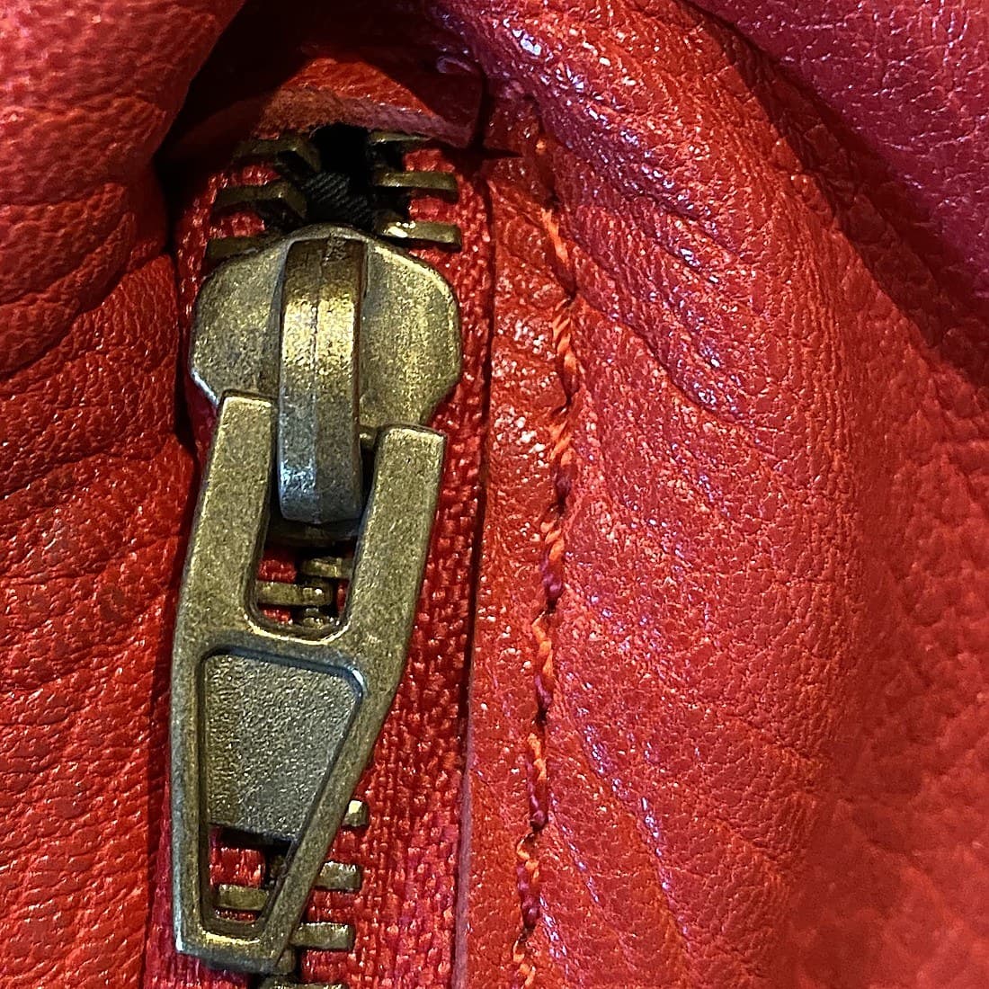 Counterfeit Alexander Wang hardware — a plain, unbranded zipper pull with no engraving at all