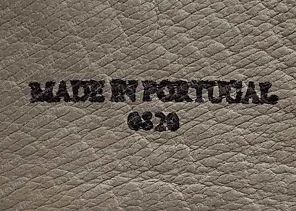 Inside a genuine AllSaints suede boot, a stamp reading MADE IN PORTUGAL in black ink on grey leather lining