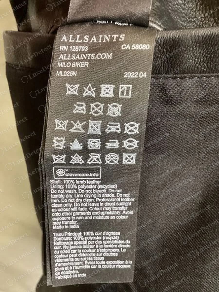Genuine AllSaints black care ribbon from a Milo biker jacket showing ALLSAINTS, RN 128793, CA 58080, ALLSAINTS.COM, MILO BIKER, ML025N, 2022 04, wash symbols and a 100% lamb leather shell