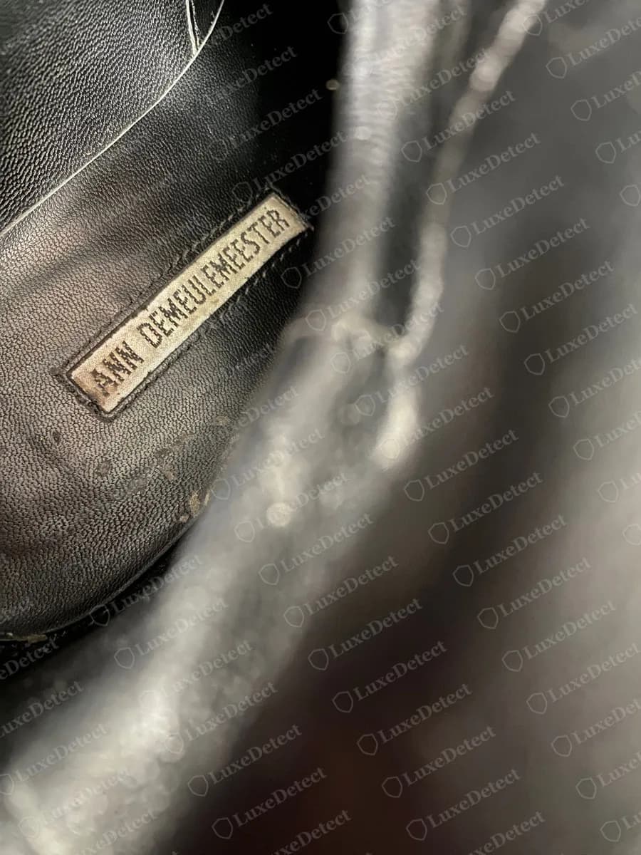 Genuine Ann Demeulemeester riding boot, pale grey insole label with ANN DEMEULEMEESTER in dark capitals, seen at an angle inside the boot