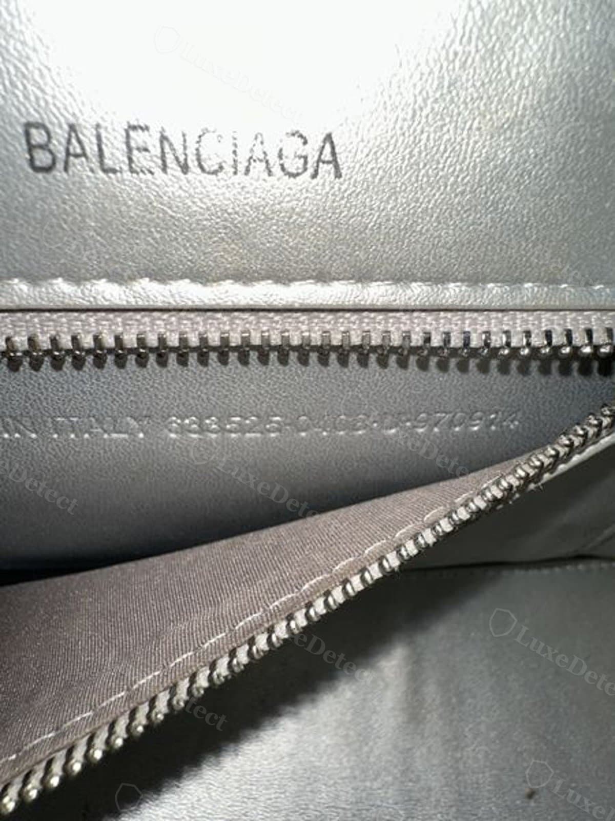 Counterfeit interior stamp: "BALENCIAGA" printed in black rather than debossed, with a run-on "MADE IN ITALY" and serial string crowded beneath it on the same panel