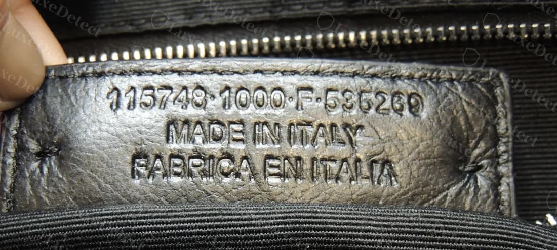 Counterfeit tab that copies the genuine layout but reads FABRICA EN ITALIA under MADE IN ITALY, with the same final group as genuine tags
