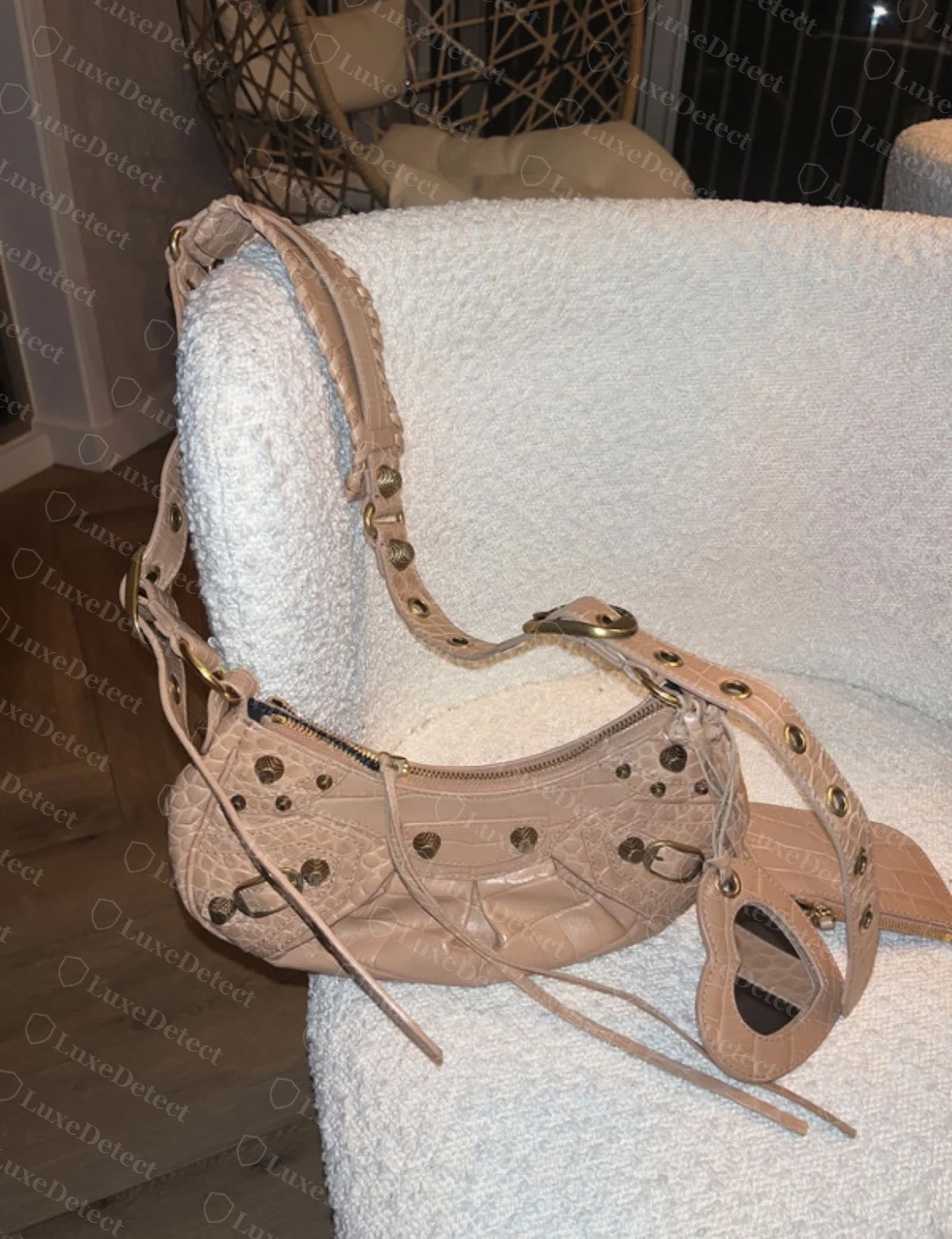 Authentic Balenciaga Cagole grommet hardware on tan croc-embossed strap — smooth polished interior ring, no visible casting seam