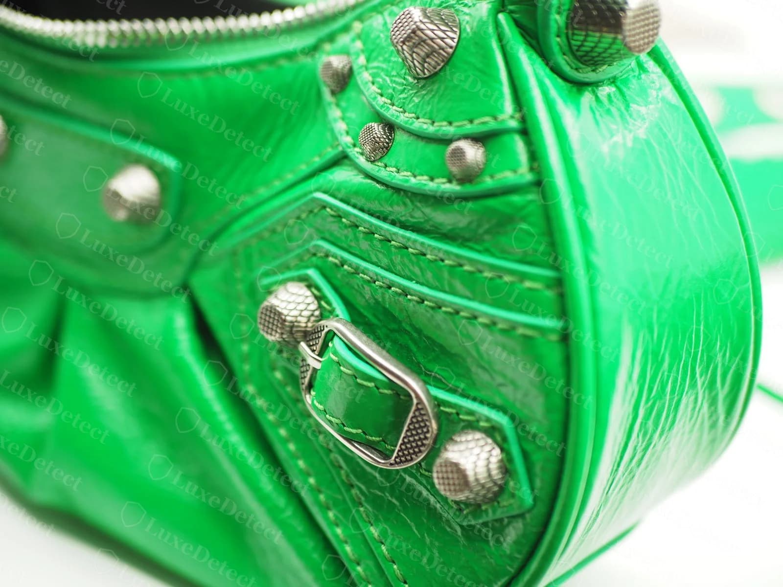 Counterfeit Balenciaga Cagole in green leather — stud finish and grain texture to compare against the authentic reference above