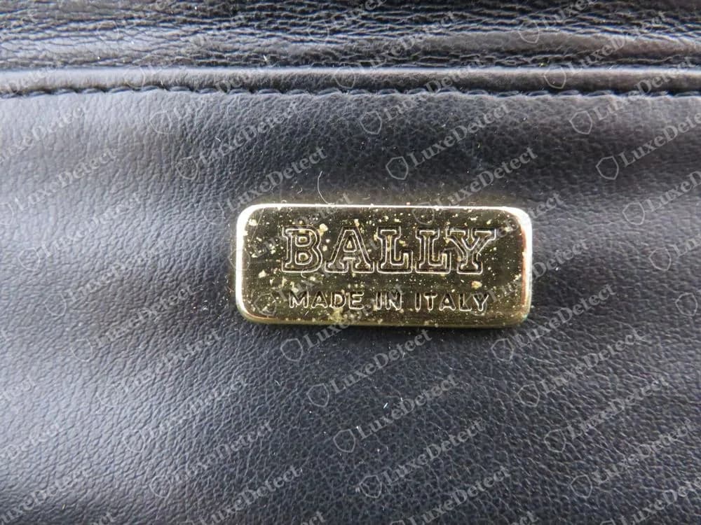 Genuine Bally gold-tone rectangular plaque engraved BALLY with MADE IN ITALY beneath, set in black leather lining