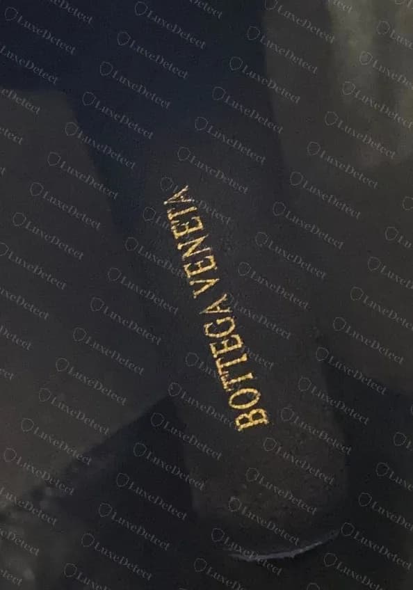 Fake Tire-style boot insole: BOTTEGA VENETA printed in gold foil on black, where genuine Tire and Lug insoles are blind-pressed.