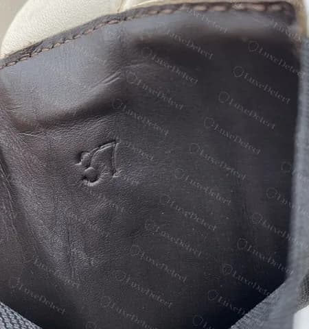 Fake Tire boot heel lining: a malformed, unevenly pressed size number with nothing under it.
