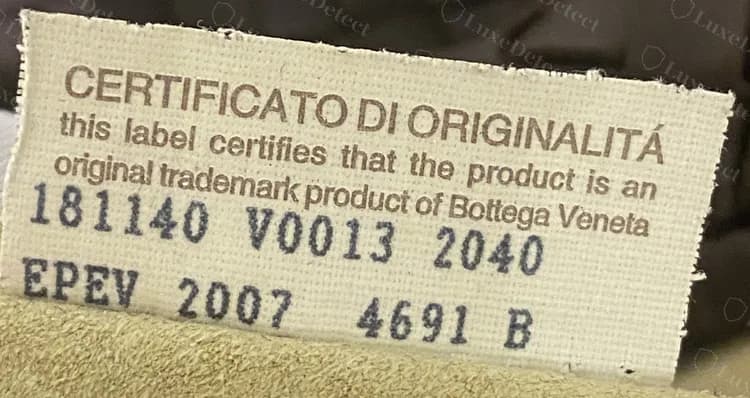 Genuine older Certificato di Originalità tag: brown heading, English sentence below, numbers in dark ink