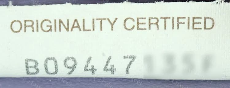 Genuine Originality Certified tag: brown heading and an evenly printed grey code (we have blurred the last characters of the code)