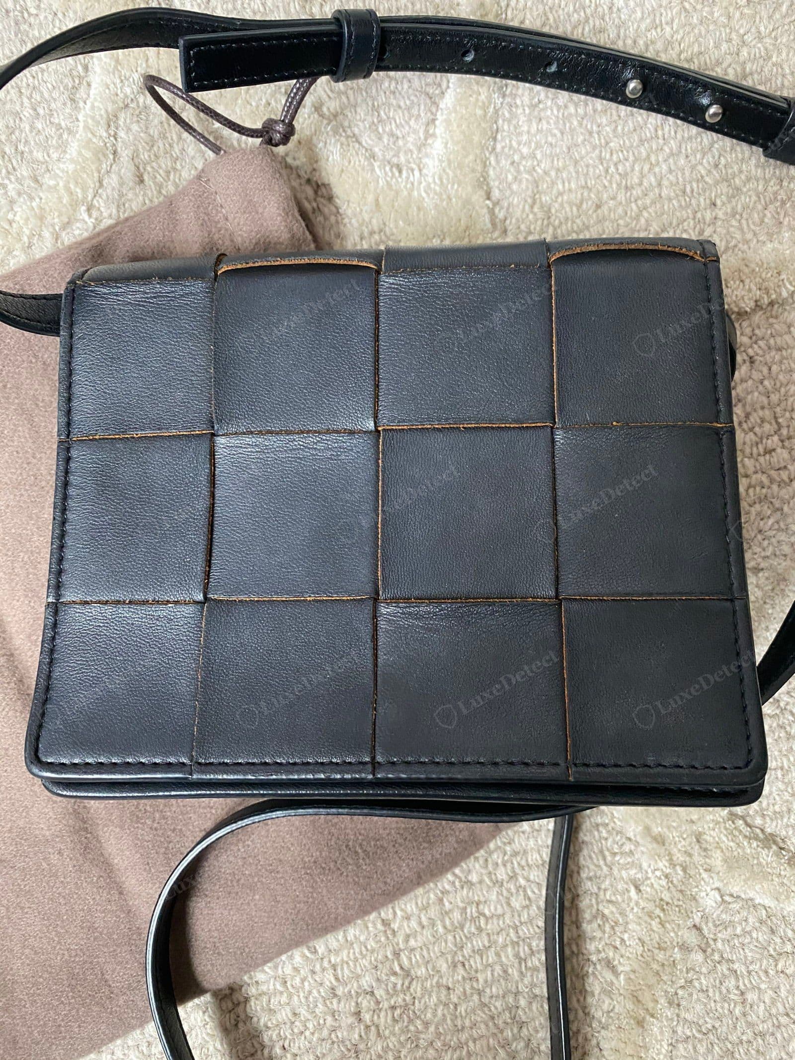 Genuine flat (non-padded) Cassette, worn: the flat maxi-intrecciato grid of large square panels, painted band edges showing tan where the finish has worn with use