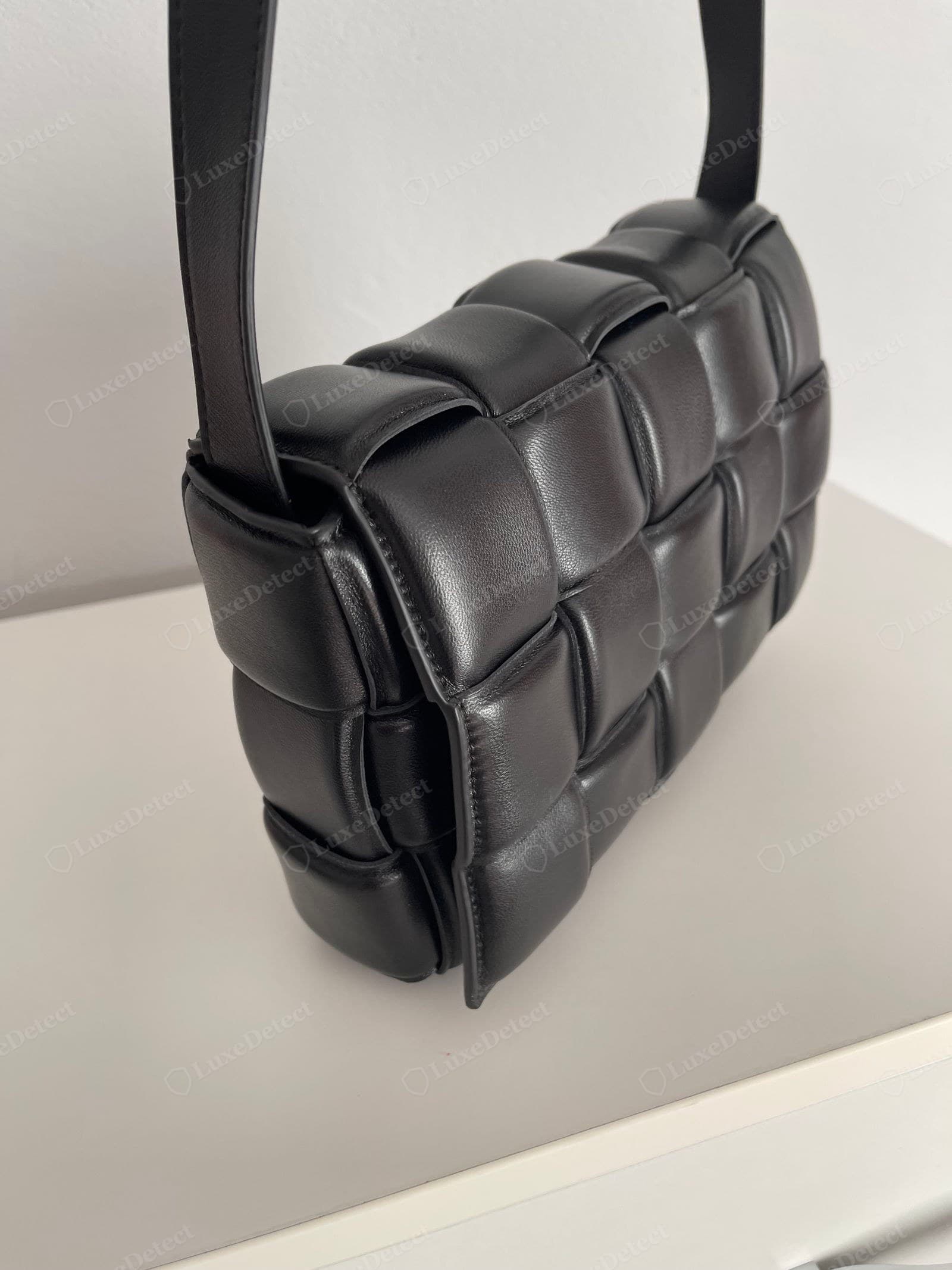Genuine Padded Cassette weave, black nappa: large plump cushions, roughly three rows by five wide, wide leather bands woven tight with no backing showing, soft rounded edges