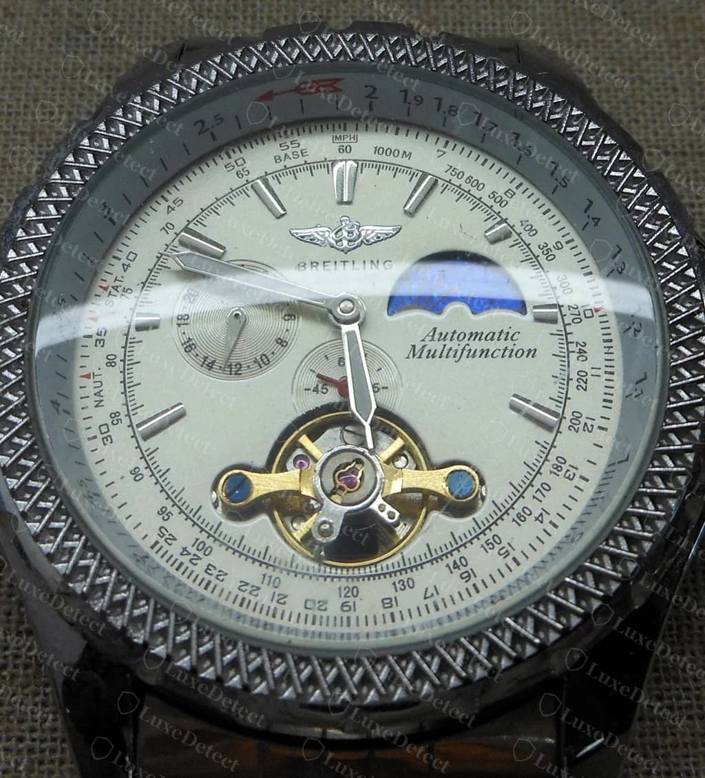 Counterfeit Breitling-signed dial combining a slide-rule scale, a moonphase window and a visible open-heart balance with the words Automatic Multifunction